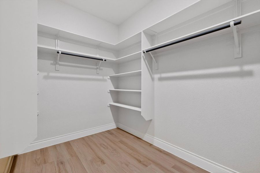 Ample shelving and hanging space defines this well-organized walk-in closet. Ample shelving and hanging space defines this well-organized walk-in closet.