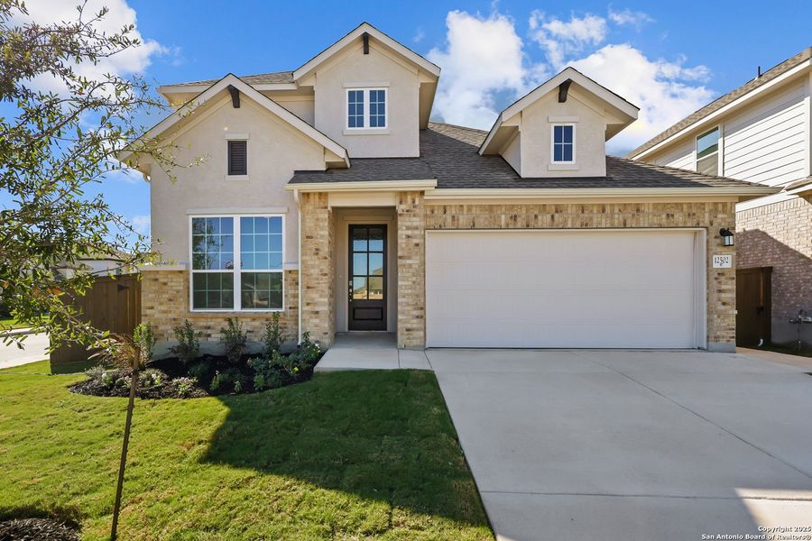 Front exterior of a new home in Stillwater Ranch, San Antonio, TX, highlighting curb appeal (Image 1). Front exterior of a new home in Stillwater Ranch, San Antonio, TX, highlighting curb appeal (Image 1).