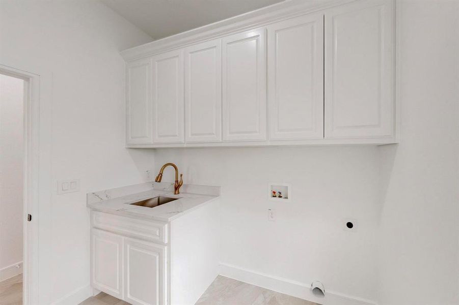 Laundry room featuring hookup for a washing machine, electric dryer hookup, and cabinet space