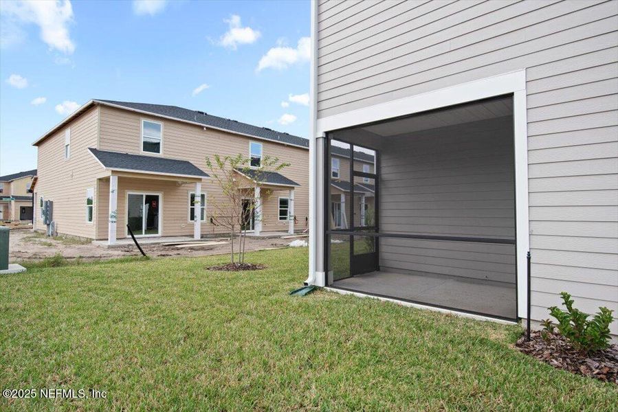 Exterior details and patio area of a home in Hardwick Farms: Hardwick Farms - Townhome Collection, Jacksonville (Image 30).
