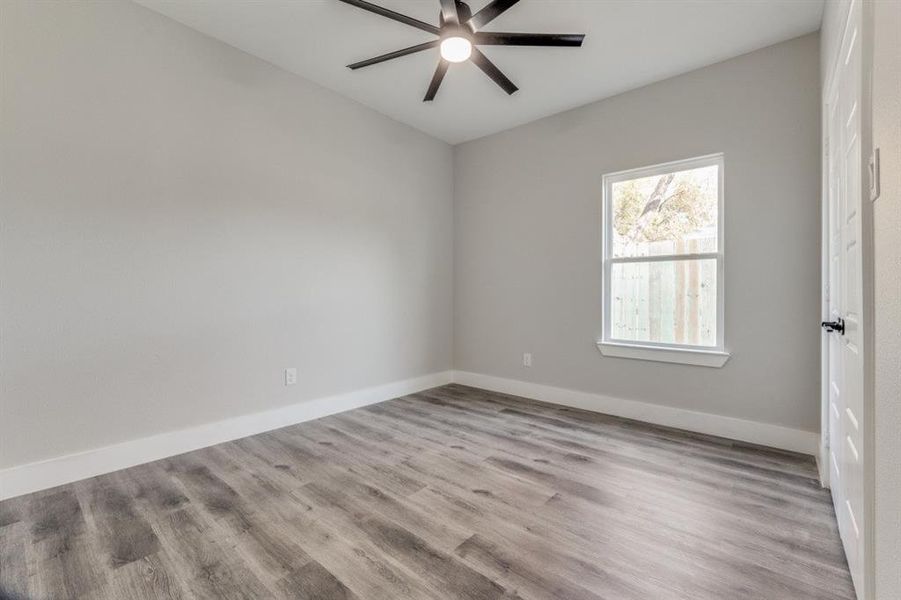 Empty room featuring light wood-type flooring and ceiling fan