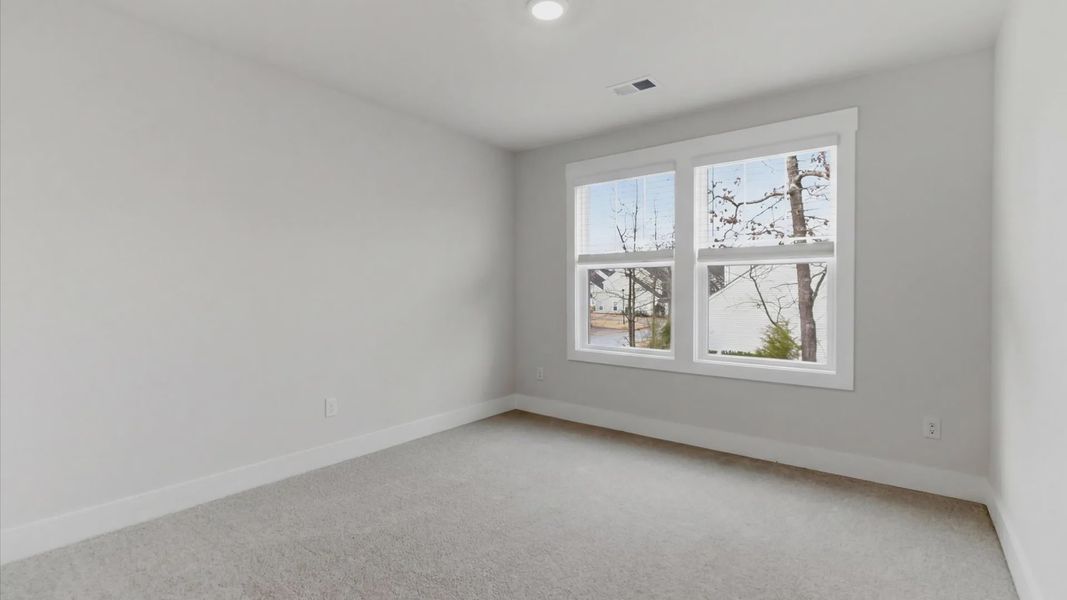 Memorable bedroom with generous proportions, a walk-in closet, and beautiful natural light through large windows in SC