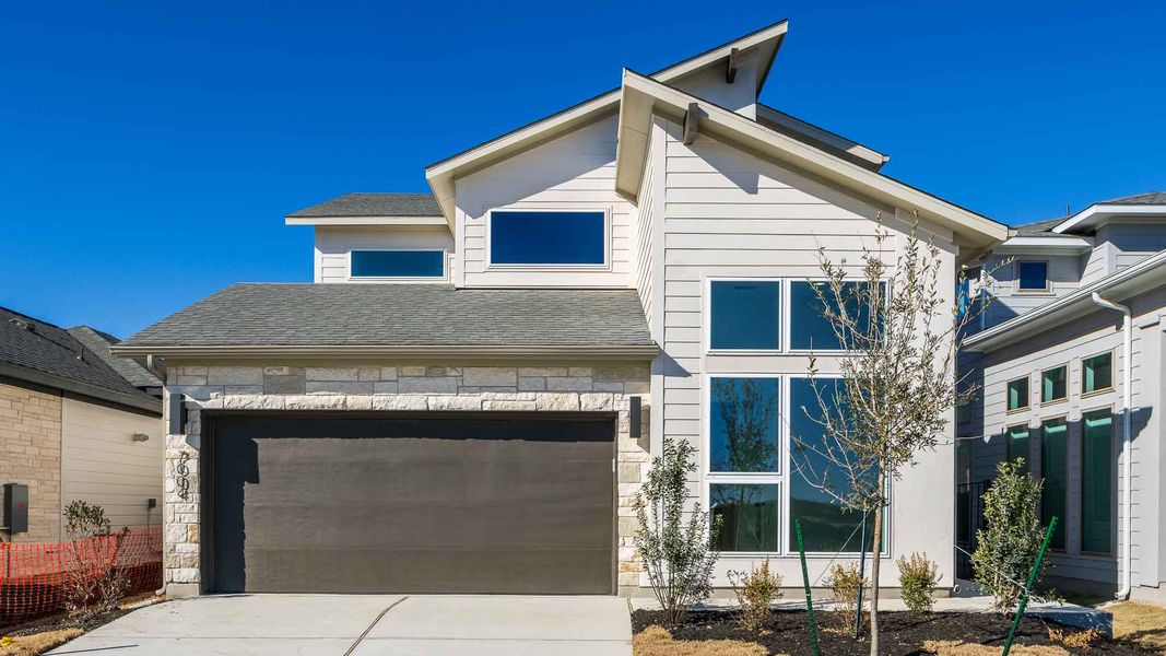 Front exterior of a new home in Easton Park, Austin, TX, highlighting curb appeal (Image 1). Front exterior of a new home in Easton Park, Austin, TX, highlighting curb appeal (Image 1).