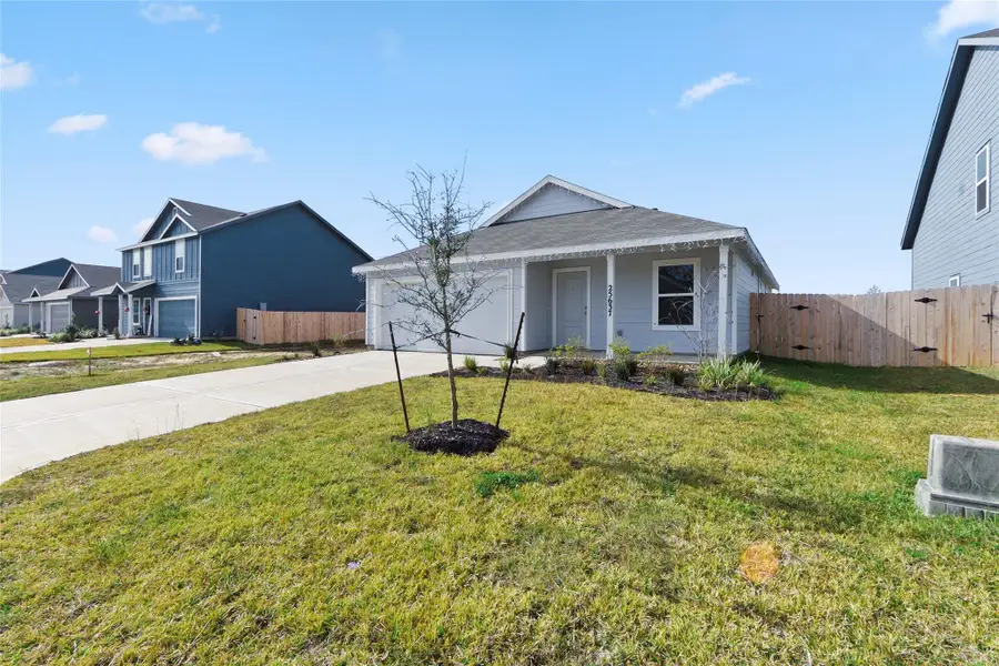 Front exterior of a new home in Pinewood Trails, Cleveland, TX, highlighting curb appeal (Image 2).