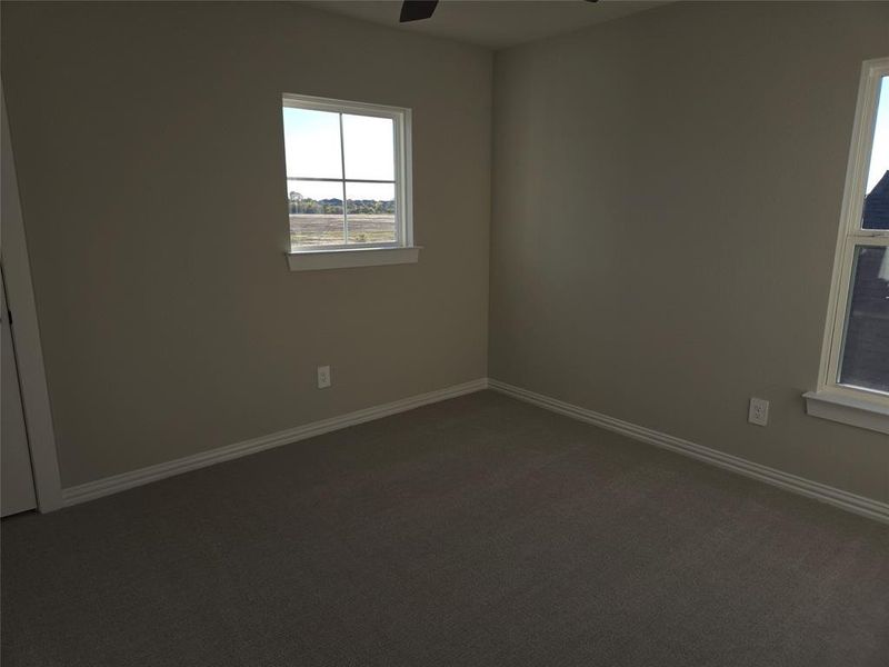 Empty room with carpet flooring and ceiling fan