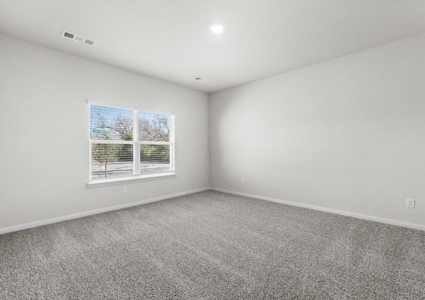 The master bedroom of the Cypress is spacious and has a large window that lets in great, natural light.