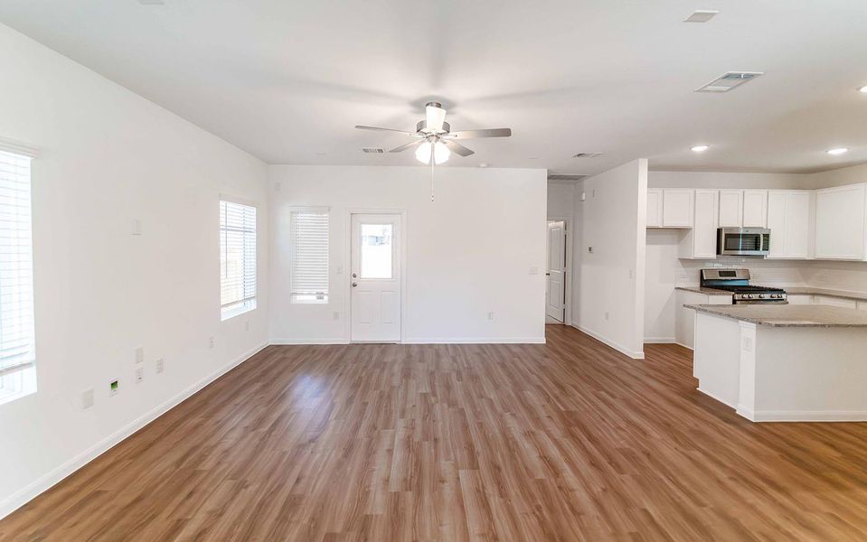Unfurnished living room featuring dark wood finished floors, recessed lighting, and a ceiling fan Unfurnished living room featuring dark wood finished floors, recessed lighting, and a ceiling fan