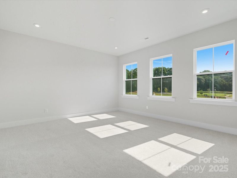 Primary Suite with Wall of Windows and Unobstructed Views.