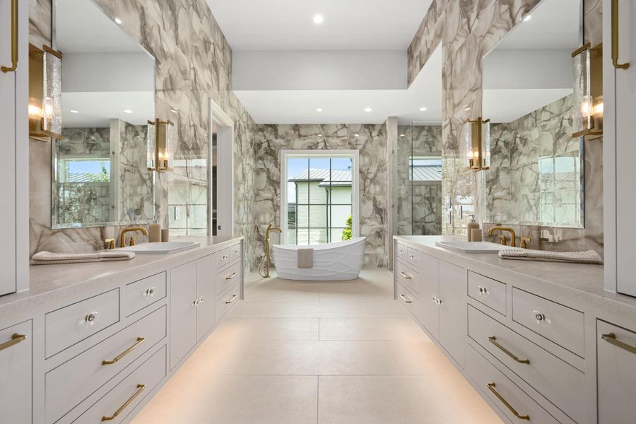 Indulge in a primary bathroom featuring a freestanding tub and double vanity with elegant fixtures.