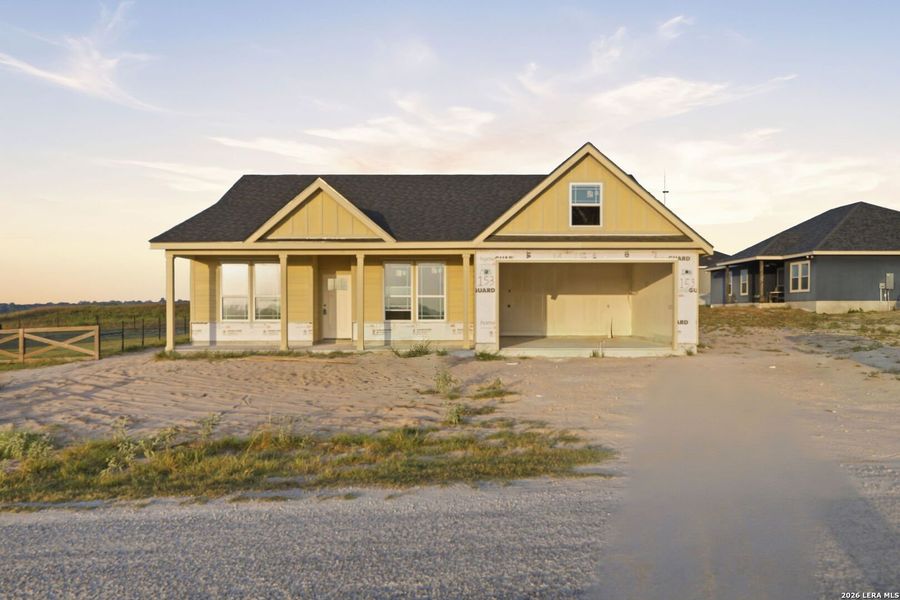 Front exterior of a new home in Las Palomas Country Club Estates, La Vernia, TX, highlighting curb appeal (Image 2). Front exterior of a new home in Las Palomas Country Club Estates, La Vernia, TX, highlighting curb appeal (Image 2).