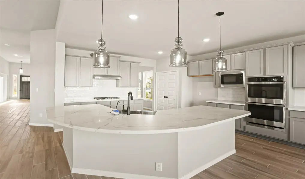 Gourmet kitchen with large curved island (*Photo not of actual home and used for illustration purposes only.)