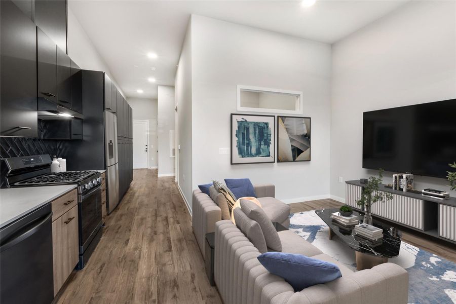 Living room with baseboards, wood finished floors, and recessed lighting