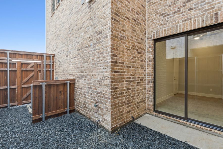 Exterior details and patio area of a home in Newman Village Townhomes, Frisco (Image 27).