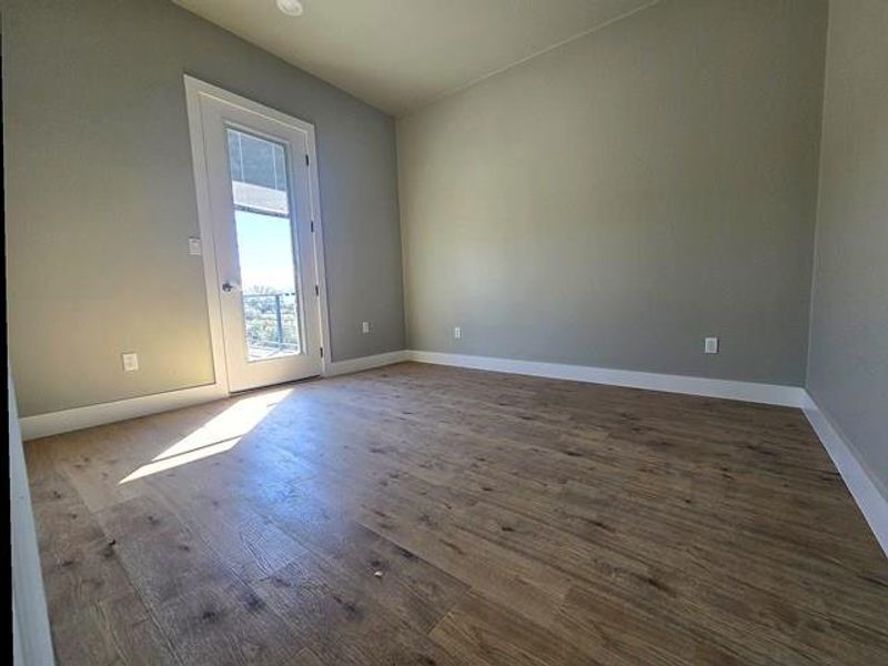 Spare room with wood finished floors and baseboards