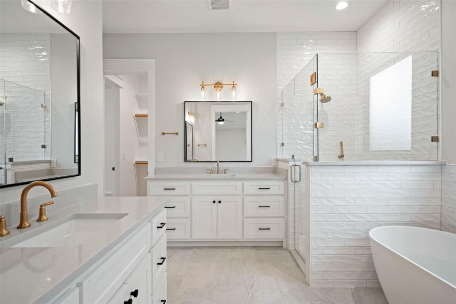 Luxurious bathroom with dual vanities and a spacious walk-in shower. Luxurious bathroom with dual vanities and a spacious walk-in shower.