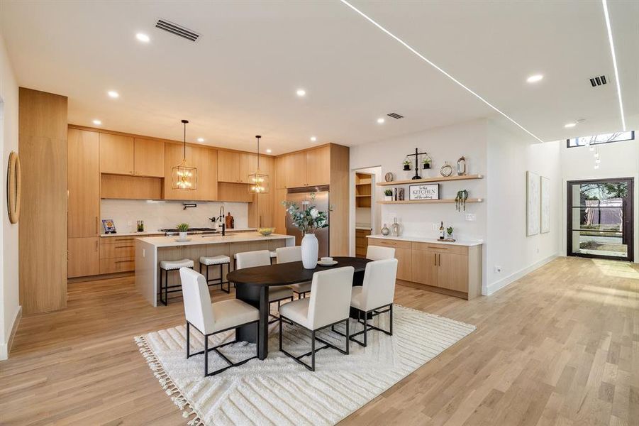 Dining space featuring sink and light hardwood / wood-style flooring