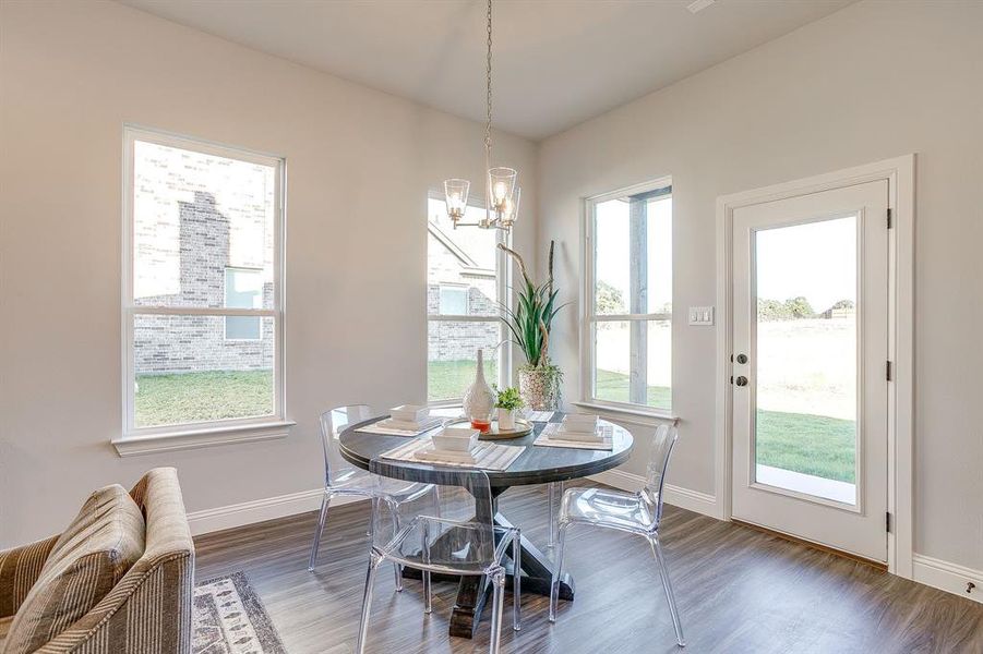 Dining area featuring wood finished floors and a chandelier
