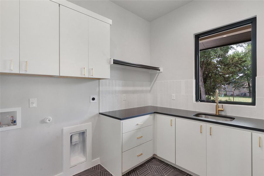 Washroom with cabinet space, hookup for a washing machine, and hookup for an electric dryer Washroom with cabinet space, hookup for a washing machine, and hookup for an electric dryer