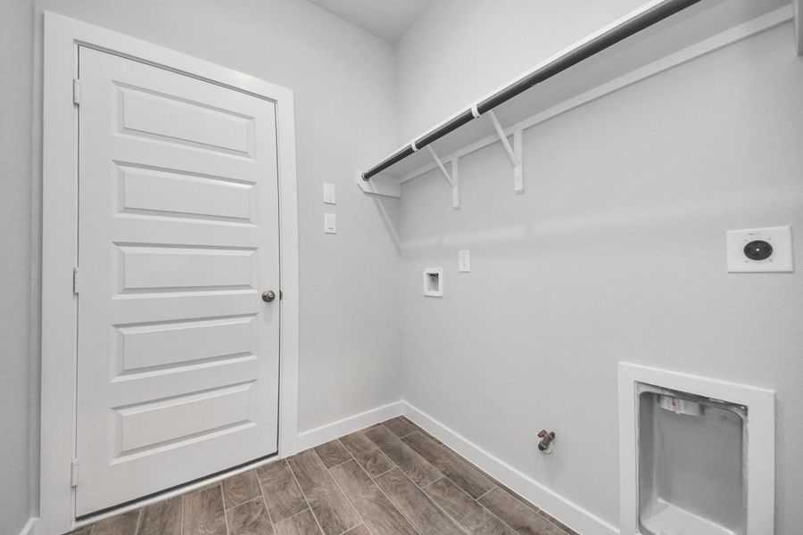 A perfect blend of functionality and comfort. Capture the essence of easy living with a first-floor laundry room, thoughtfully equipped with shelving for effortless organization. Both electric and gas connections available.
