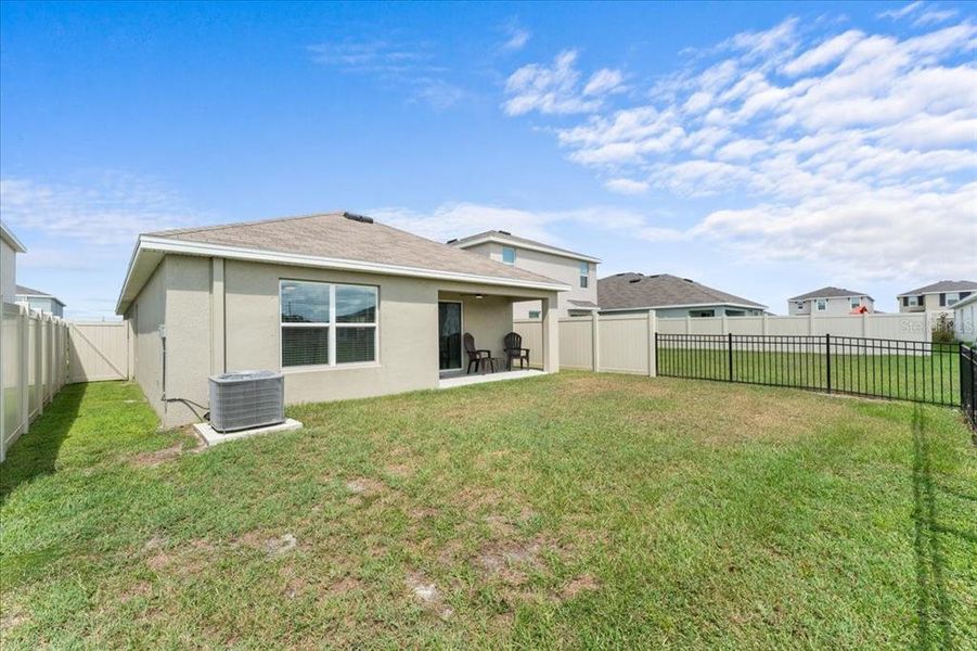 Exterior details and patio area of a home in Bella Lago, Parrish (Image 21).