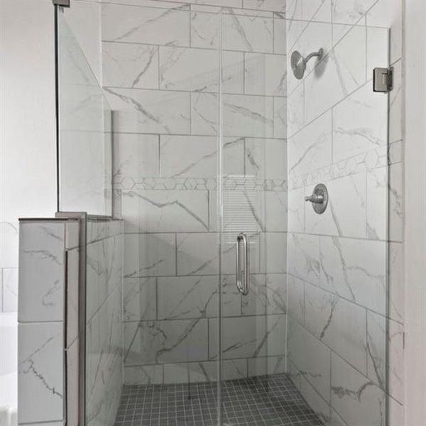 Elegant glass framed walk in shower with high end fixtures. **This image is from another Saratoga Home with similar floor plan - Myrtle Floorplan.**