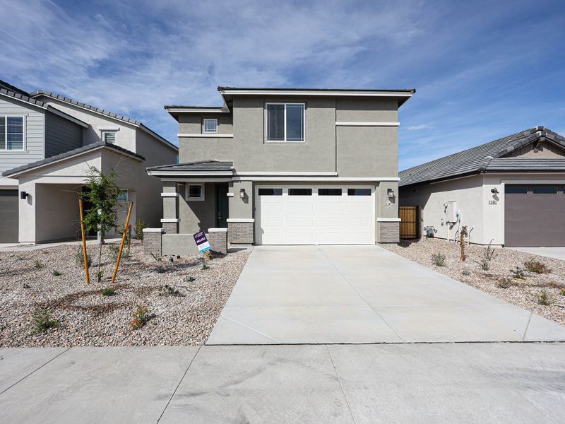 A driveway with a house in the background. A driveway with a house in the background.