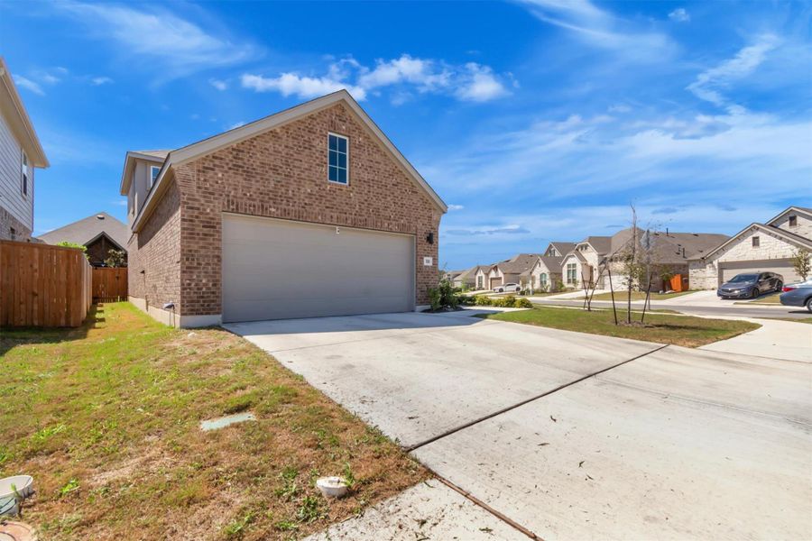 Front exterior of a new home in Crosswinds, Kyle, TX, highlighting curb appeal (Image 24).