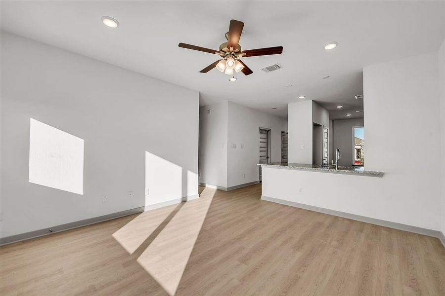 Unfurnished living room featuring recessed lighting, light wood finished floors, and a ceiling fan