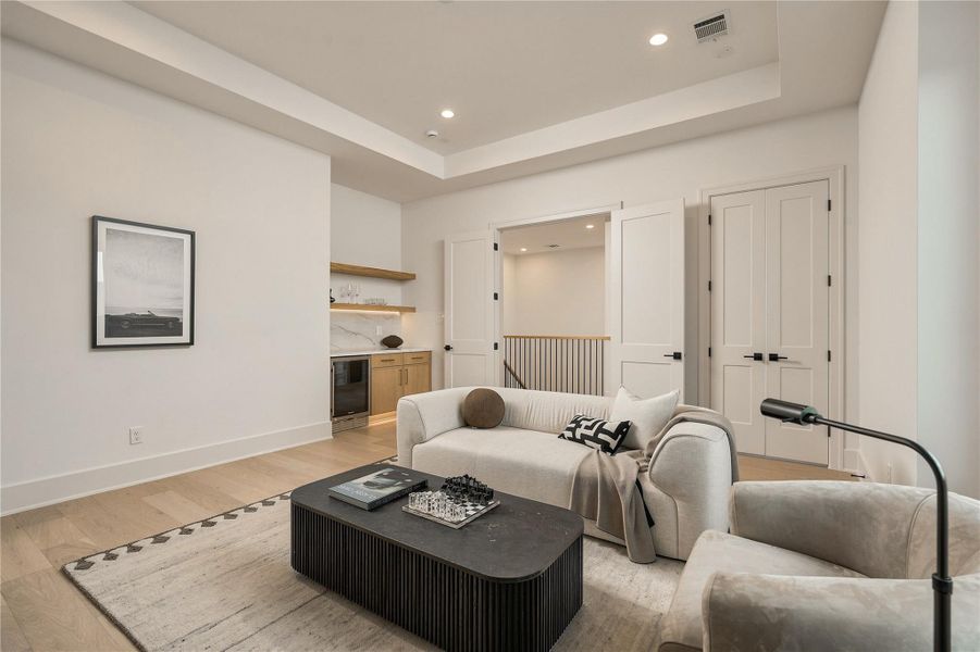The dedicated game room creates a true second living space upstairs, complete with a custom dry bar, beverage cooler, dedicated storage, and pre-wiring for surround sound.