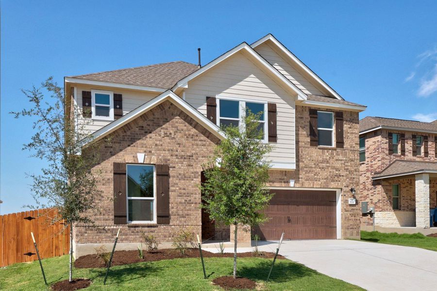 Front exterior of a new home in Salerno - Classic Collection, Round Rock, TX, highlighting curb appeal (Image 20). Front exterior of a new home in Salerno - Classic Collection, Round Rock, TX, highlighting curb appeal (Image 20).