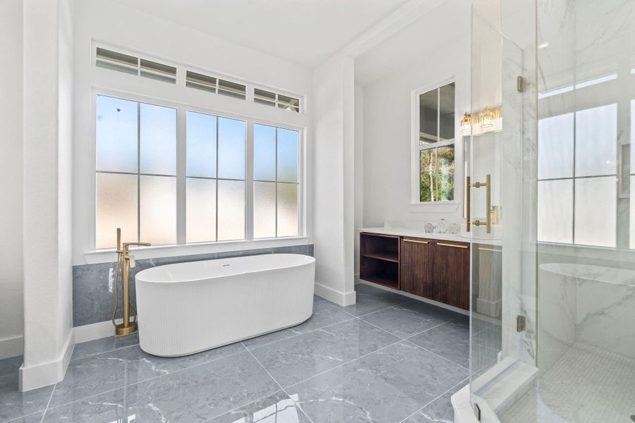 Primary bathroom with private shower and tub. Separate sinks on each side of the bathroom
