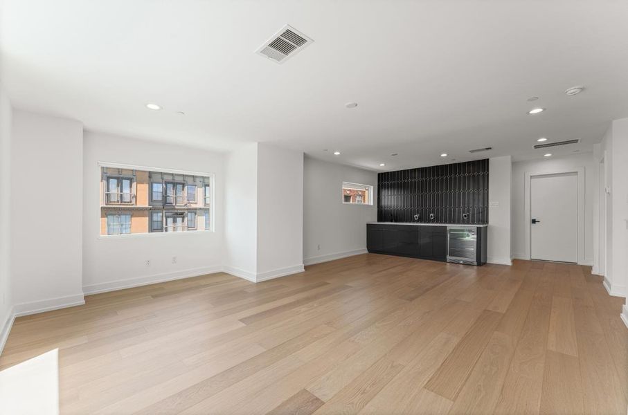 And a spacious 4th floor great room. With built in Bar, and Powder Room