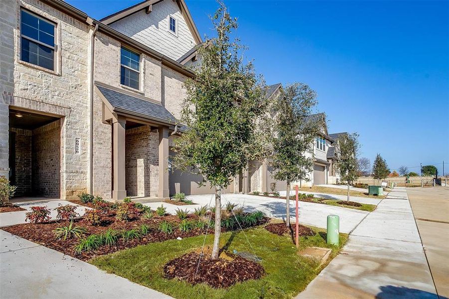 View of front of home featuring driveway and stone siding