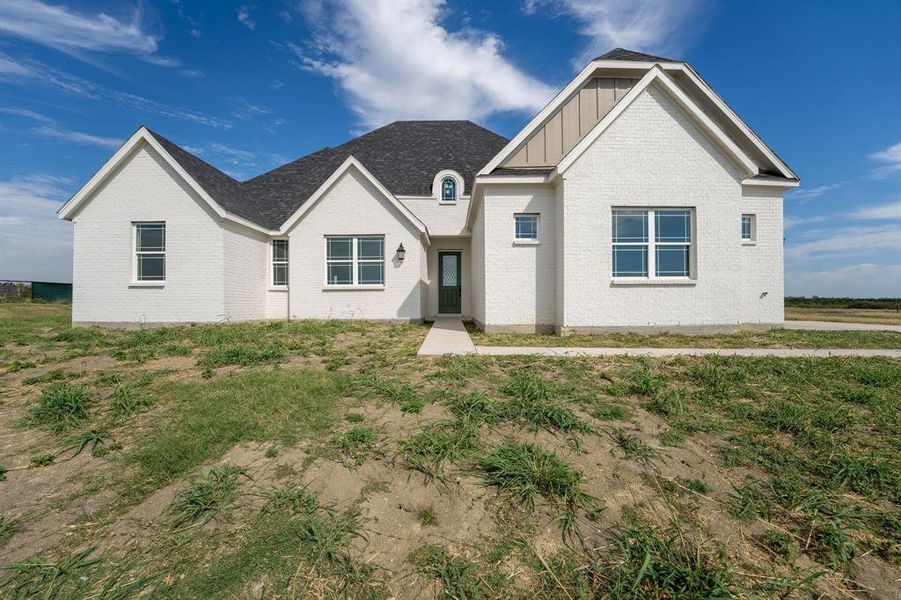View of front of house with board and batten siding and brick siding View of front of house with board and batten siding and brick siding