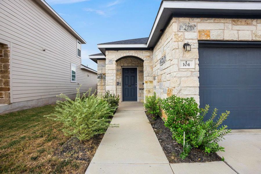 Doorway to property with stone siding