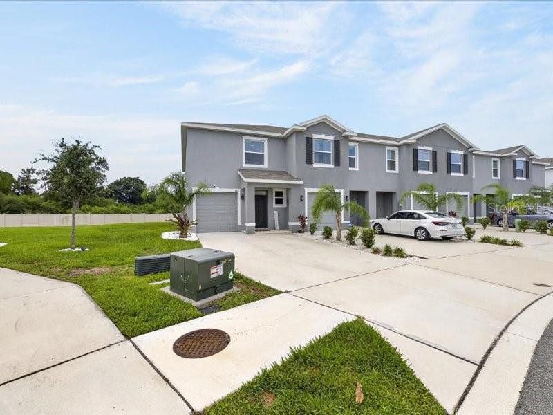 Front exterior of a new home in , Apollo Beach, FL, highlighting curb appeal (Image 31).