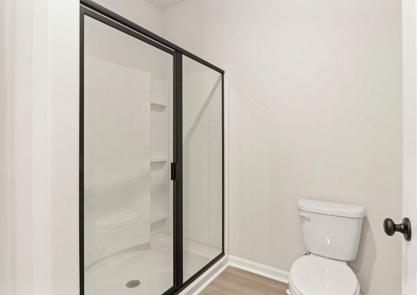 This bathroom has a glass-enclosed shower