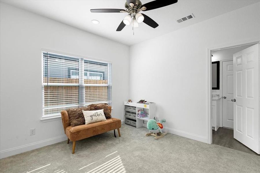 Living area featuring carpet flooring, ceiling fan, and recessed lighting Living area featuring carpet flooring, ceiling fan, and recessed lighting