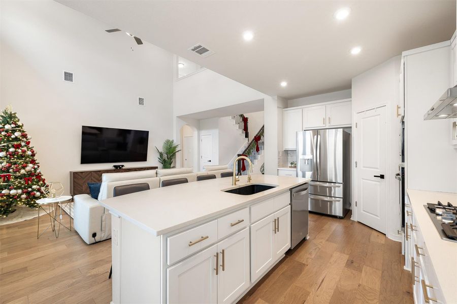 Quartz countertops offer plenty of workspace and pair smoothly with the stainless steel built in appliances