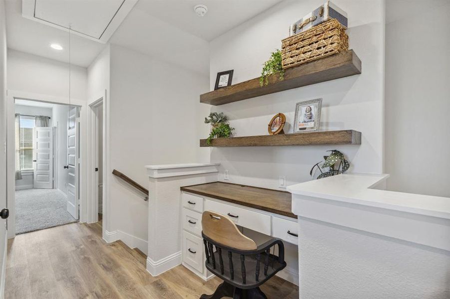 Office area with light hardwood / wood-style floors