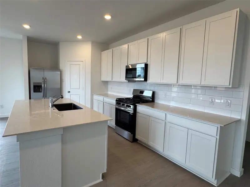 Spacious kitchen boasting tons of storage! This photo is a representation, not the actual homesite.