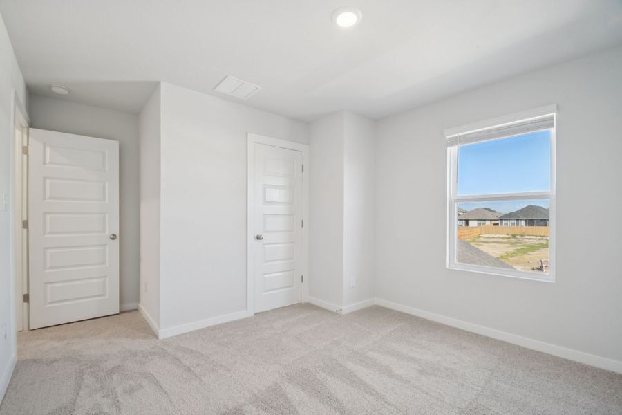 A room with white doors and a window.