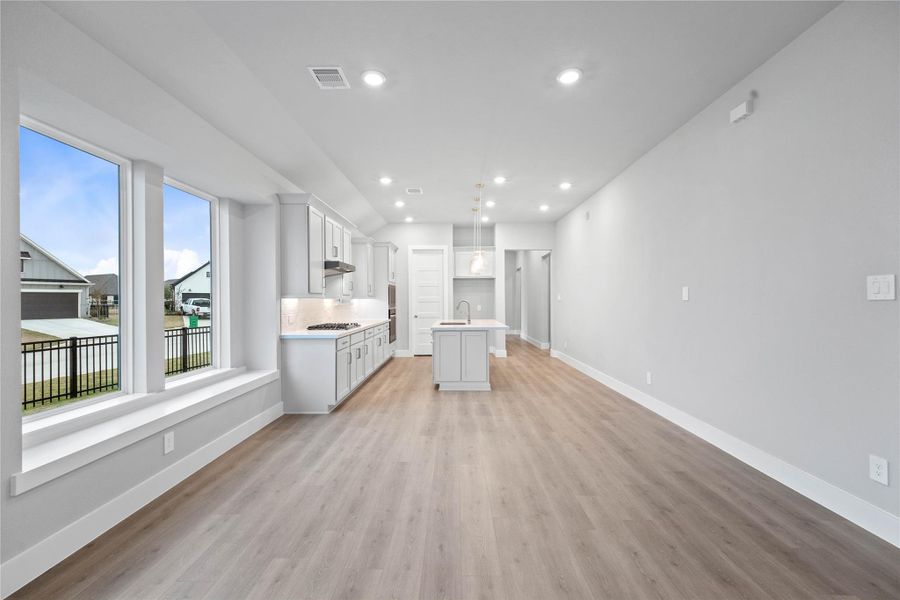 Create lasting memories around the table with family and friends in the dining! It showcases high ceilings, large windows, laminate flooring, and recessed lighting for a warm and welcoming atmosphere.