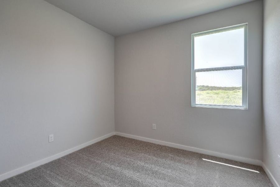 A room with a window and a carpet. A room with a window and a carpet.