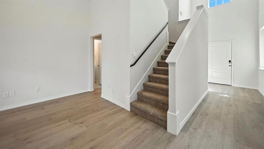 Stairs with a towering ceiling and wood finished floors Stairs with a towering ceiling and wood finished floors