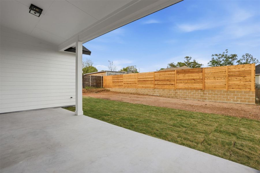 Fenced backyard featuring a patio