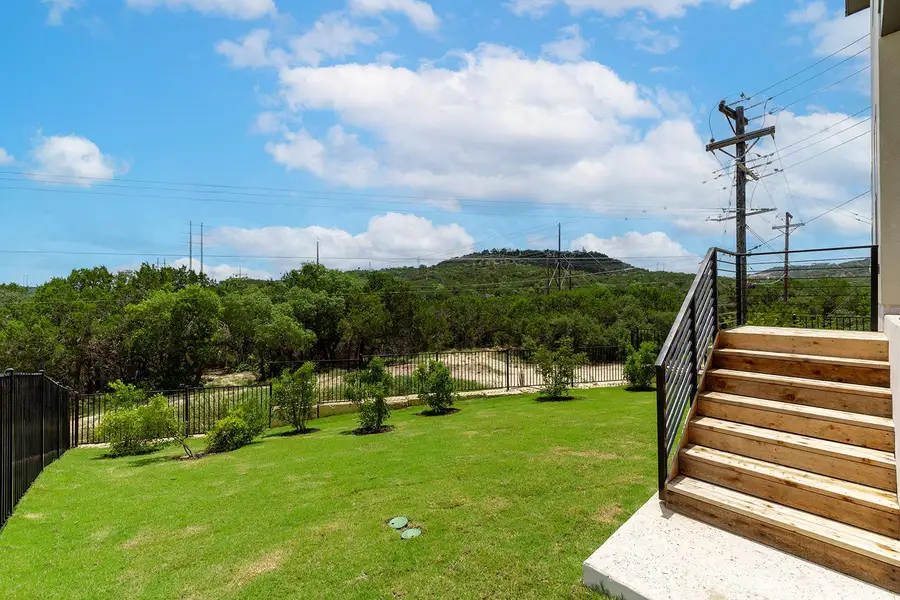 Rod iron fenced backyard from lower deck