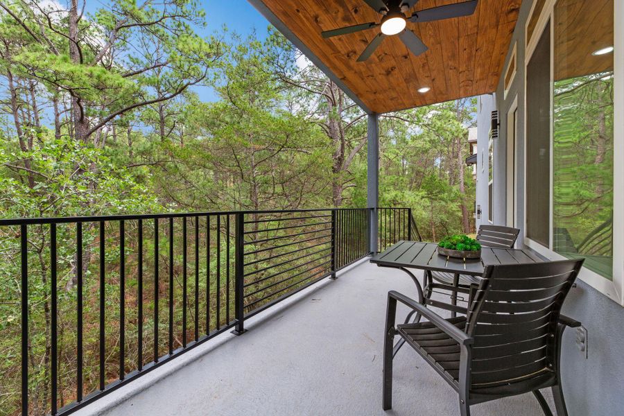 A tranquil covered balcony offers serene views of the surrounding natural landscape.