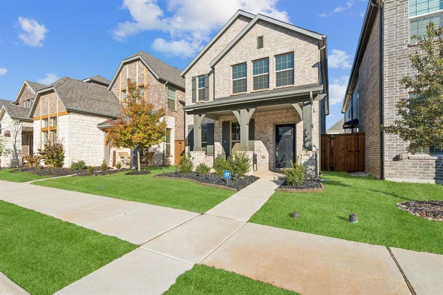 View of front of house featuring covered porch and brick siding