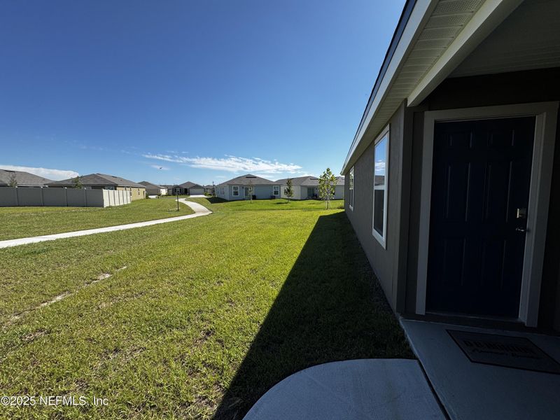 Front exterior of a new home in The Arbors, Jacksonville, FL, highlighting curb appeal (Image 25).